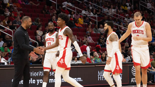 Rockets head coach Ime Udoka low fives Houston Rockets guard Jalen Green after the Miami Heat called timeout.